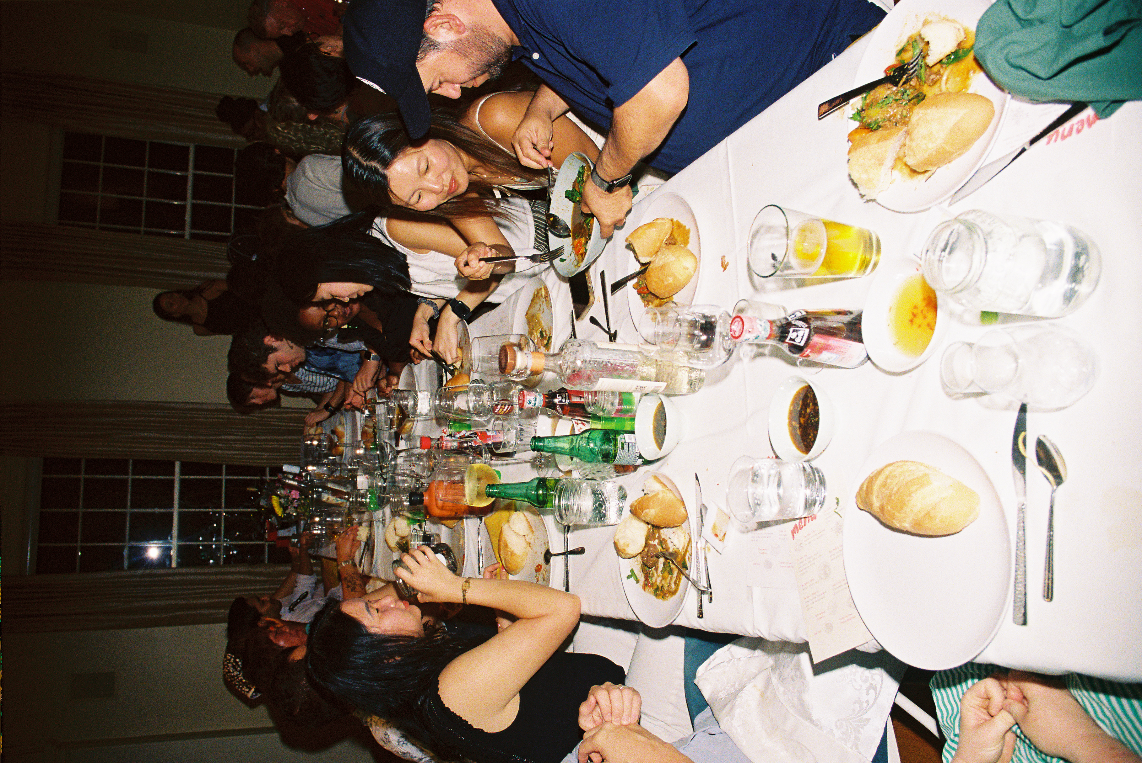 Guests seated around a long table during a Nêm Nếm dinner event.